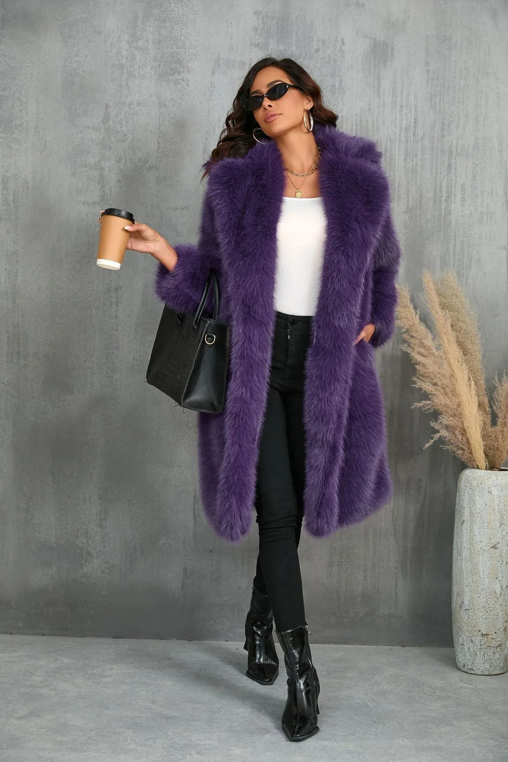 Woman wearing a purple faux fur coat, holding a coffee cup and a handbag