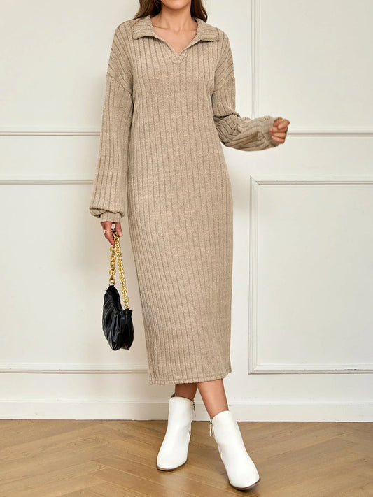 Woman wearing a beige ribbed knit midi dress with a collared V-neck and long sleeves, paired with white ankle boots and a black handbag.