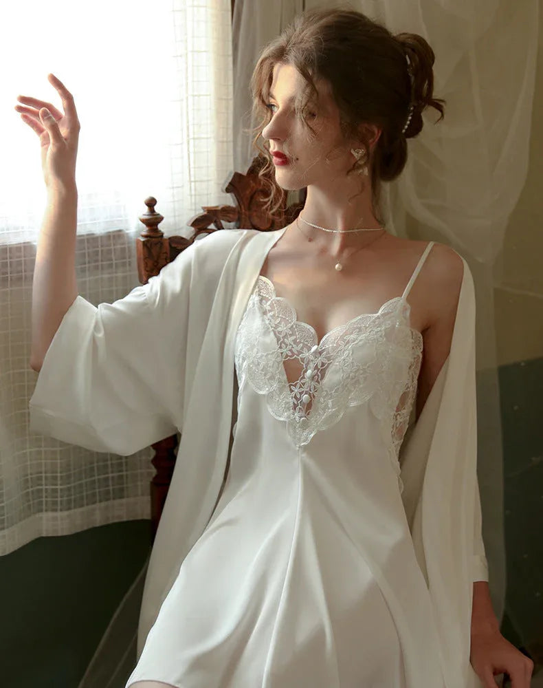 Woman wearing a white satin slip dress with lace trim and a matching robe. Main image