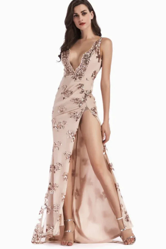 Woman in a blush sequined evening gown with a high leg slit and plunging neckline.