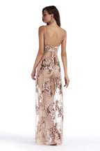 Back view of a woman in a sheer sequined maxi dress