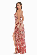 Side view of a woman in a sequined evening gown, showcasing the high slit and open back.