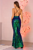 Back view of a woman in a floor-length, form-fitting mermaid gown with a V-neckline and spaghetti straps, showcasing an open back with crisscross detailing and the radiating sequin pattern.