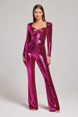 Front view of a woman modeling a glamorous pink sequined jumpsuit with a sweetheart neckline and a matching belt.