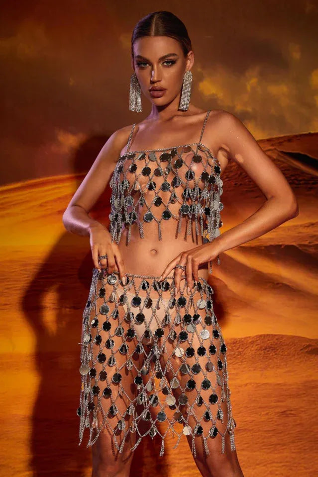Woman wearing a silver sequin crop top and mini skirt set with fringe detailing Main image