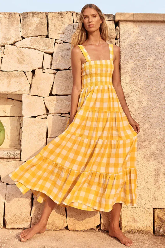 Woman wearing a yellow gingham tiered maxi dress