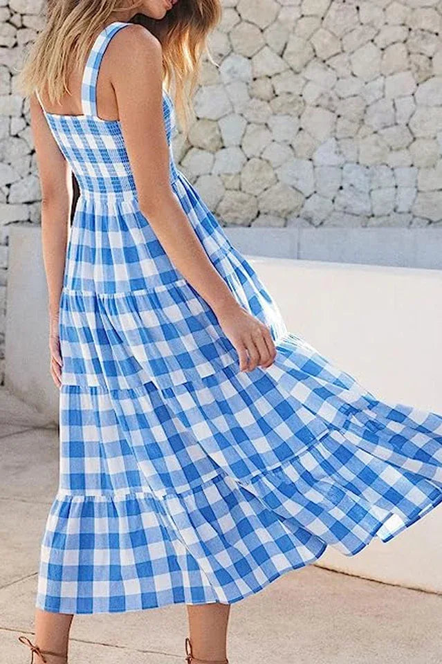 Woman in a blue gingham tiered maxi dress with skirt flowing