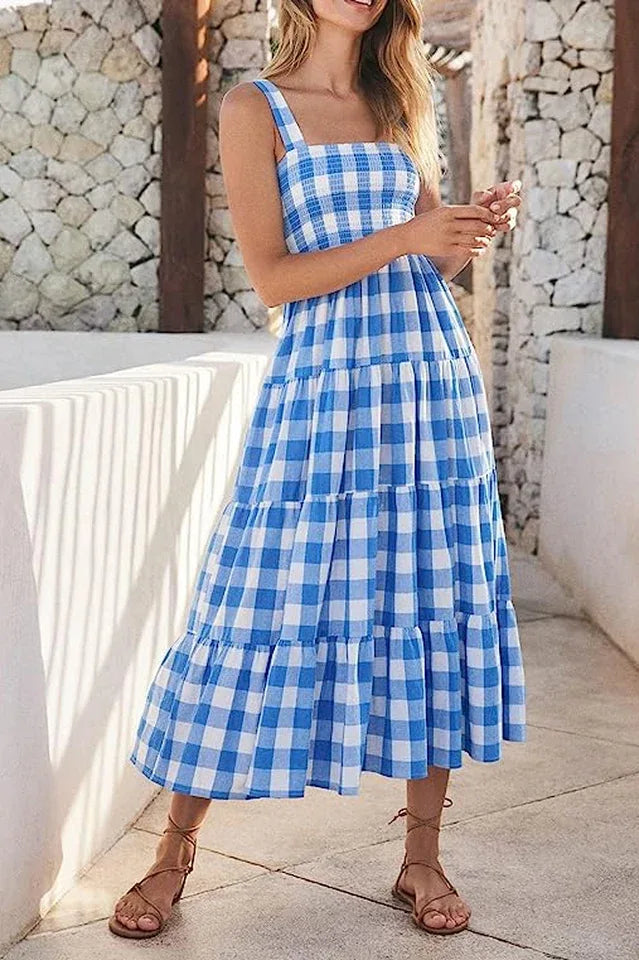 Woman wearing a blue gingham tiered maxi dress standing outdoors