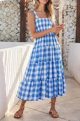 Woman wearing a blue gingham tiered maxi dress standing outdoors