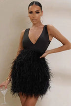 Woman wearing a black sleeveless mini dress with a deep V-neckline and a full feather skirt, holding a cocktail glass.