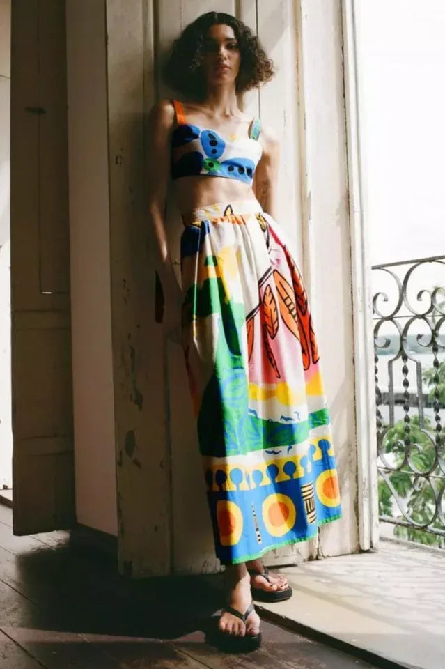Woman wearing a colorful abstract print crop top and maxi skirt set Main image