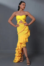 woman wearing a yellow strapless dress with a cut-out waist and ruffled asymmetrical hem
