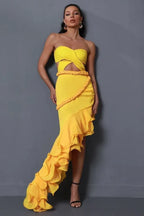 front view of a woman in a yellow strapless gown with a high-low ruffled skirt