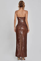 Back view of a bronze sequined evening gown featuring a fitted silhouette, spaghetti straps, and a slit at the back.