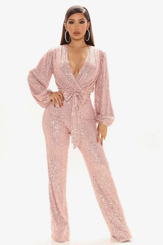 Woman wearing a pink sequined jumpsuit with a V-neck and balloon sleeves