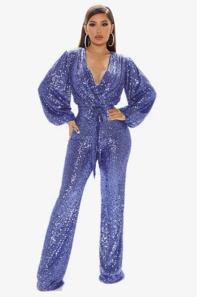 Woman wearing a blue sequined jumpsuit with a V-neck and balloon sleeves