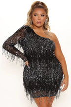 Model wearing a black sequined one-shoulder mini dress with fringe detailing.