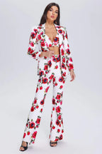 Woman wearing a white floral print suit with a matching bralette