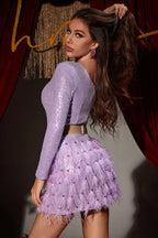 Full body shot of a woman in a lavender sequin one-shoulder mini dress with feather trim, holding a silver clutch.