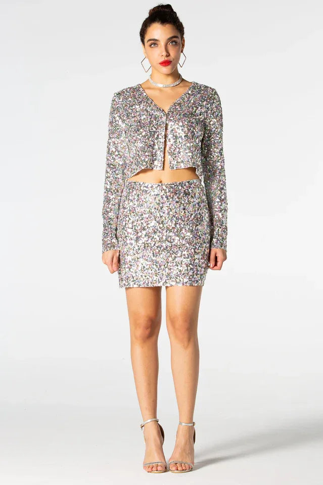 Woman wearing a sequined cropped jacket and matching mini skirt, front view Main image