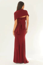 Rear view of a woman wearing a red strapless mermaid gown with a scarf tied in a bow at the back