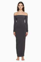 Model wearing a dark grey off-the-shoulder maxi dress from the front
