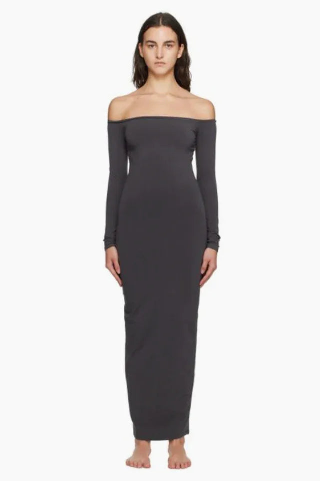 Model wearing a dark grey off-the-shoulder maxi dress from the front