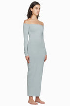 Model wearing a light blue off-the-shoulder maxi dress from the side