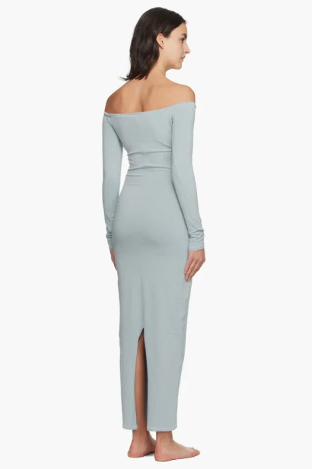 Model wearing a light blue off-the-shoulder maxi dress from the back