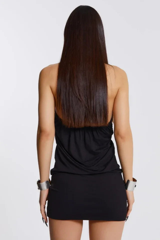 Back view of a woman in a black halter neck mini dress.