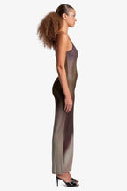 Woman wearing a sheer, ombre knit maxi dress with spaghetti straps, side view.