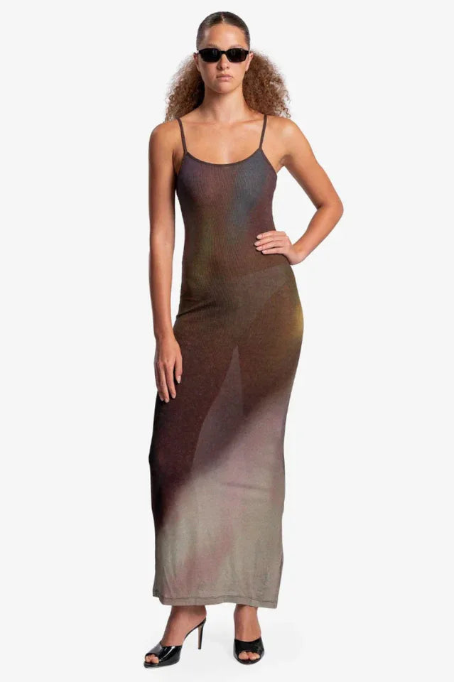 Woman wearing a sheer, ombre knit maxi dress with spaghetti straps and sunglasses, hand on hip, front view.