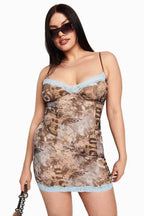 Plus-size model wearing a brown graphic print mini dress with light blue lace trim