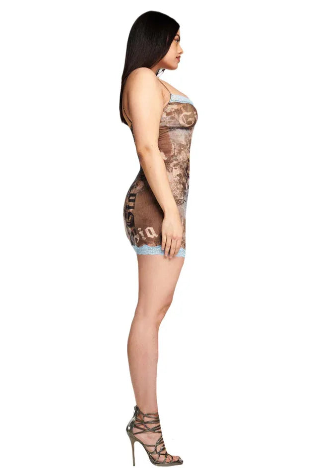 Side profile of a model wearing a brown graphic print mini dress with light blue lace trim