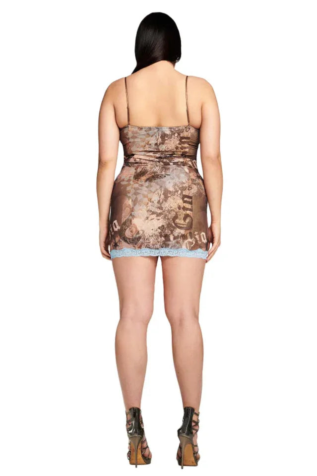 Back view of a model wearing a brown graphic print mini dress with light blue lace trim