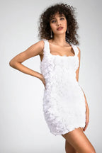 Woman in a white floral applique mini dress, front view