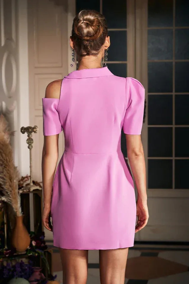 Back view of a pink mini dress with a structured silhouette and cold-shoulder design
