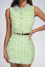 Close-up of a lime green textured tweed crop top and mini skirt set with embellished collar.
