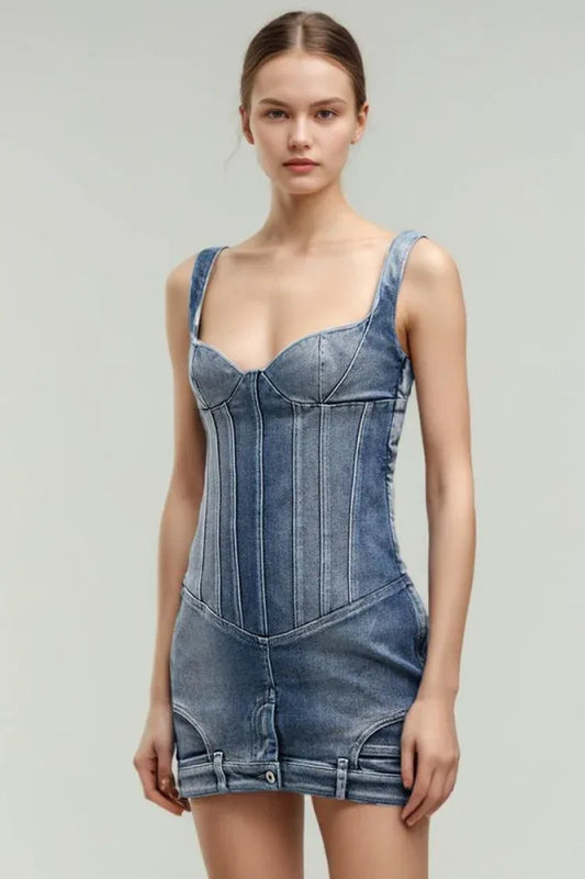 Model wearing a blue denim corset mini dress with strap shoulders, viewed from the front.