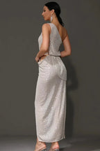 Back view of a woman in a silver sequined one-shoulder gown