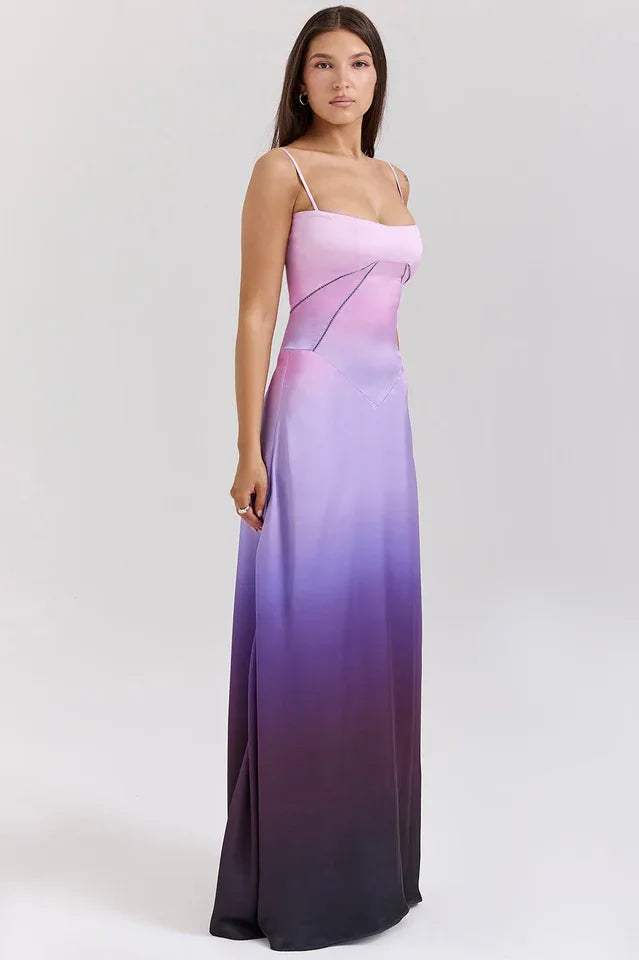 Woman wearing a pink and purple ombre satin maxi dress with spaghetti straps and a square neckline, shown from the side.