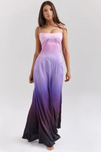 Woman wearing a pink and purple ombre satin maxi dress with spaghetti straps and a square neckline, shown from the front.