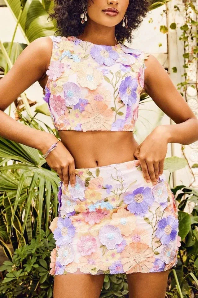 Model wearing a floral crop top and mini skirt set, front view Main image