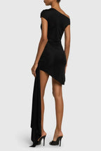 Back view of black one-shoulder asymmetrical hem dress with draped skirt detail