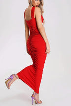 back view of a red ruched maxi dress with halter neckline