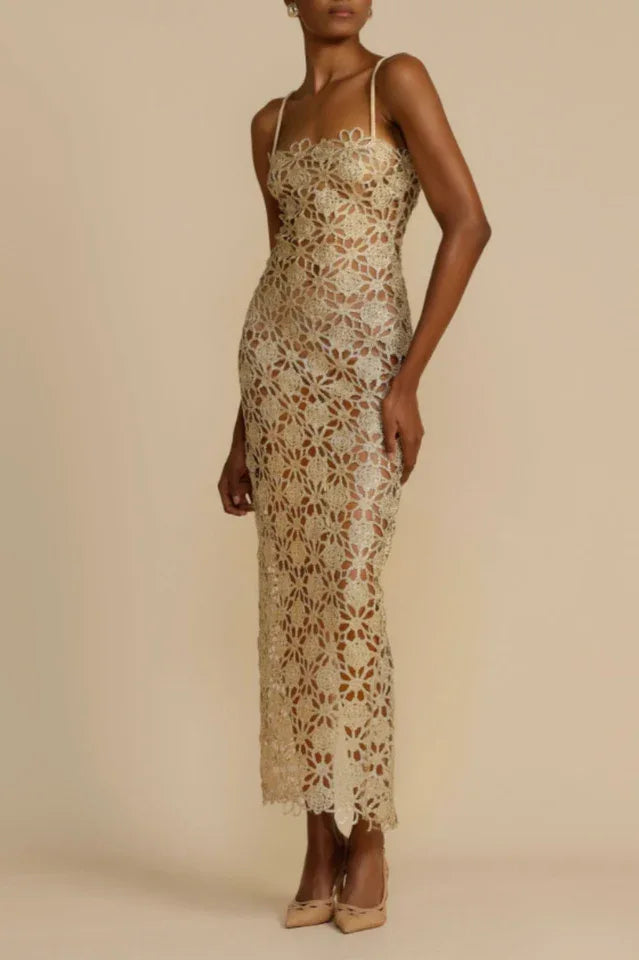 Woman wearing a gold floral lace maxi dress with spaghetti straps