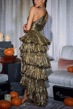 Back view of a woman in a gold metallic tiered ruffle halter dress.