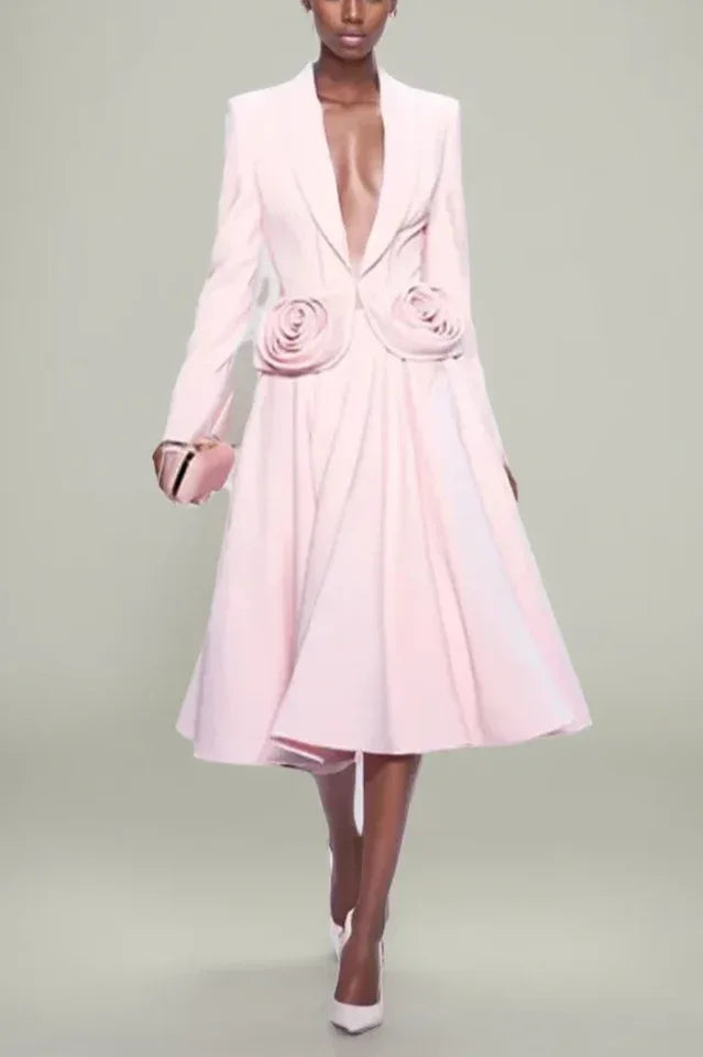 Model wearing a pink blazer and skirt set with rose embellishments Main image