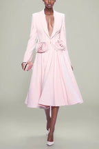 Model wearing a pink blazer and skirt set with rose embellishments