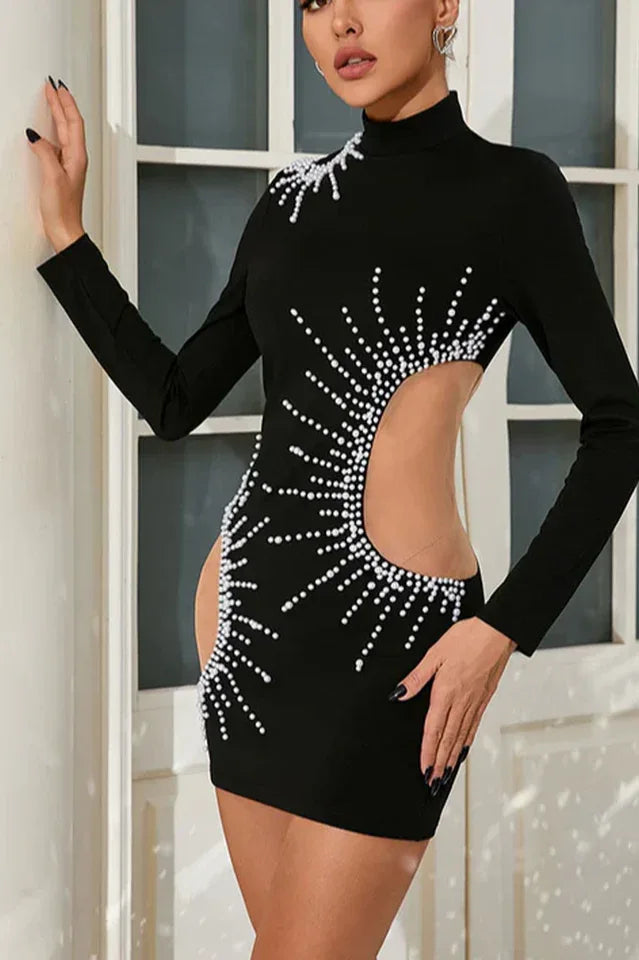 Side profile of a woman in a black embellished mini dress.